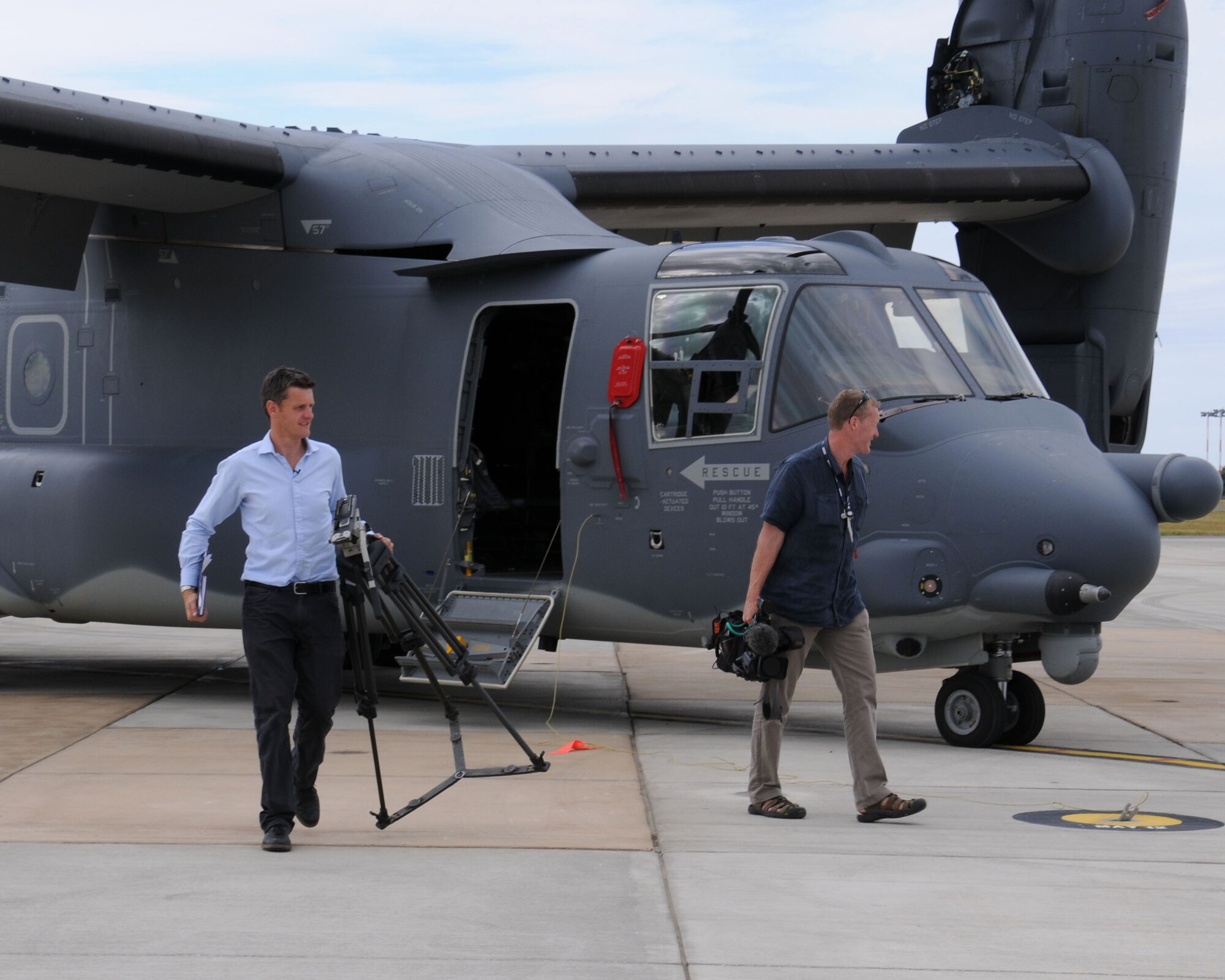 Members of the local media and tail spotters participate in a 352nd Special Operations Group media day July 26, 2013, on RAF Mildenhall, England. Photographers, broadcasters, journalists and tail spotters saw the newly-assigned MC-130J Commando II and CV-22 Osprey aircraft. (U.S. Air Force photo by Gina Randall/Released)