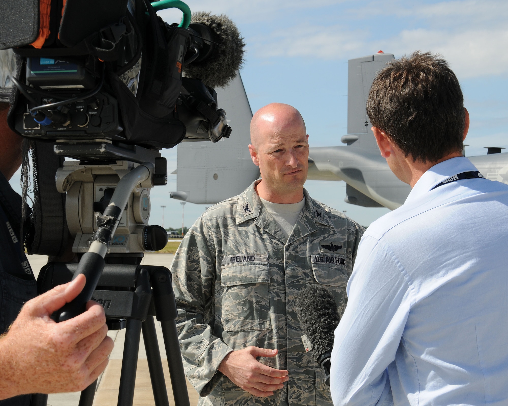 Center, Col. Christopher Ireland, 352nd Special Operations Group commander, speaks to members of the media and tail spotter community during a media day event July 26, 2013, on RAF Mildenhall, England. During the event, Ireland and multiple 352nd SOG Airmen gave interviews about the unit’s expansion and new aircraft. Participating media and tail spotters were given tours of MC-130J Commando II and CV-22 Osprey aircraft static displays. (U.S. Air Force photo by Gina Randall/Released)