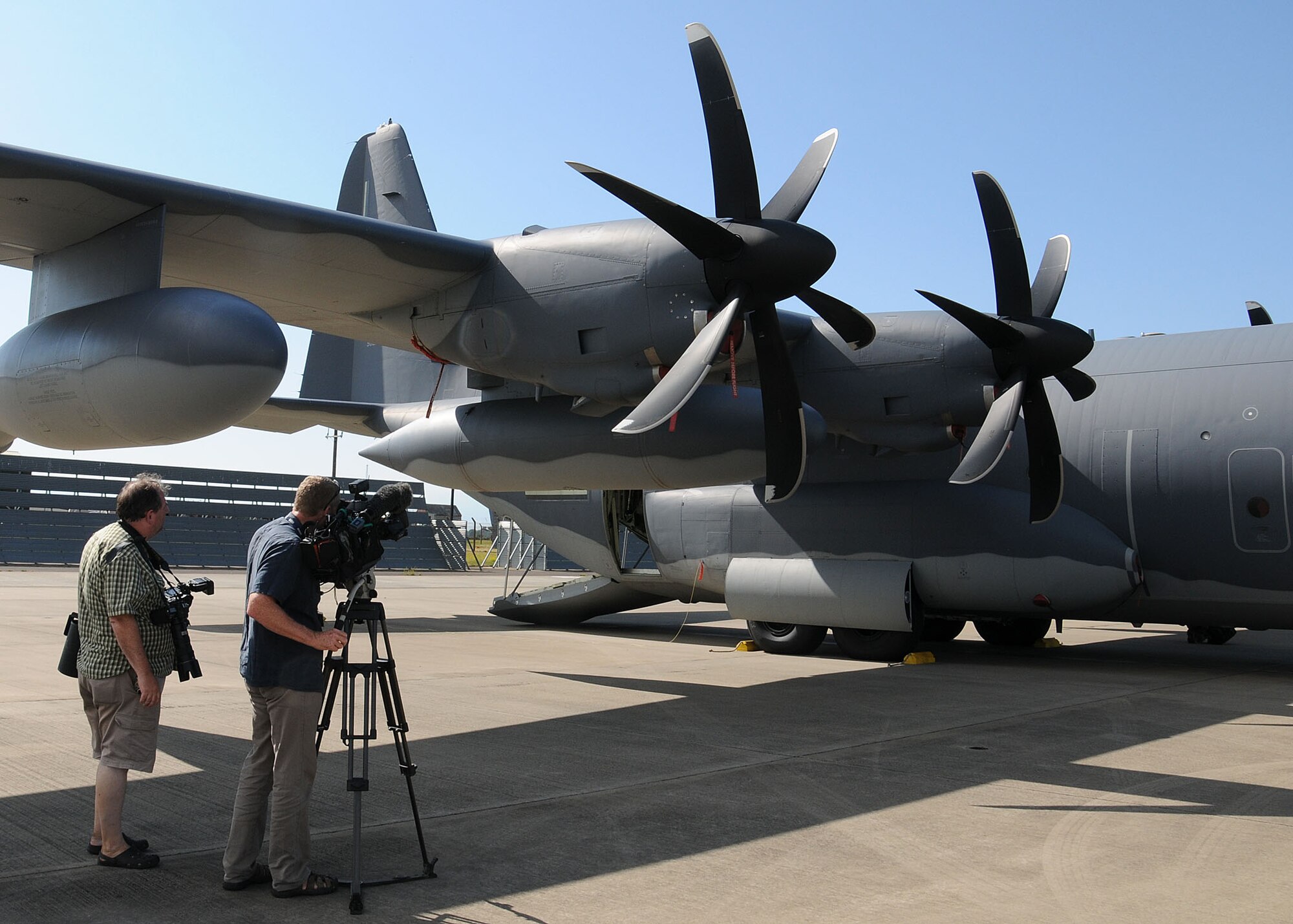 Members of the local media and tail spotters participate in a 352nd Special Operations Group media day July 26, 2013, on RAF Mildenhall, England. Photographers, broadcasters, journalists and tail spotters saw the newly-assigned MC-130J Commando II and CV-22 Osprey aircraft. (U.S. Air Force photo by Gina Randall/Released)