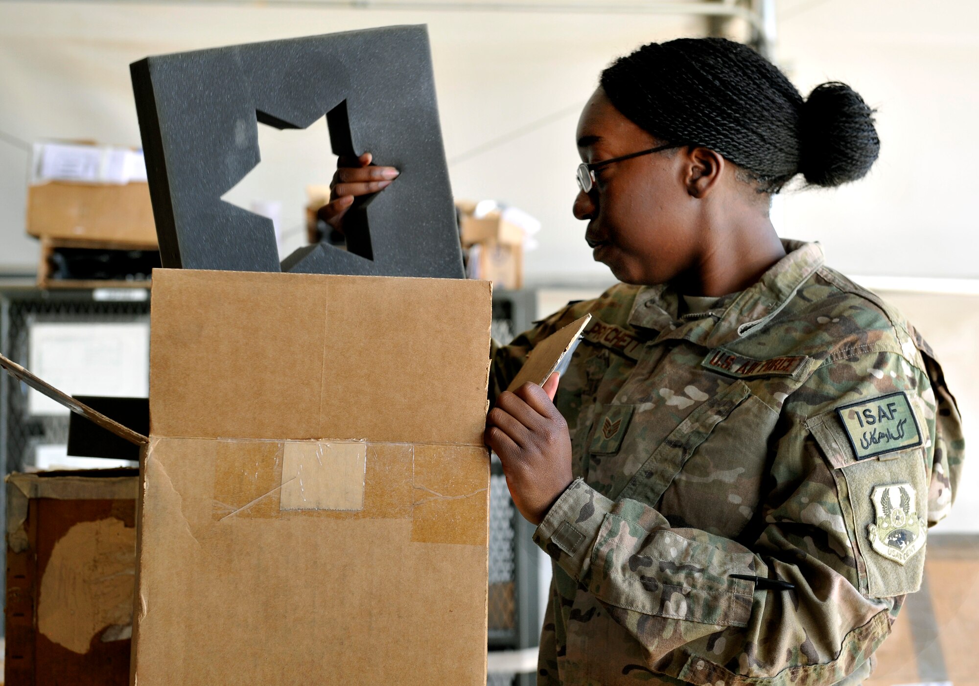 Staff Sgt. Sabrina Pritchett, 455 Expeditionary Logistics Readiness Squadron flight service center technician, looks for a customers ordered part in the C-130 aircraft parts store on Bagram Airfield, Afghanistan, May 30, 2013. Pritchett is in charge of maintaining accountability for all aircraft parts due in for maintenance and assisting customers picking up parts. Pritchett is deployed from Moody AFB and a native of Jackson, Ala. (U.S. Air Force photo/ Staff Sgt. Stephenie Wade)