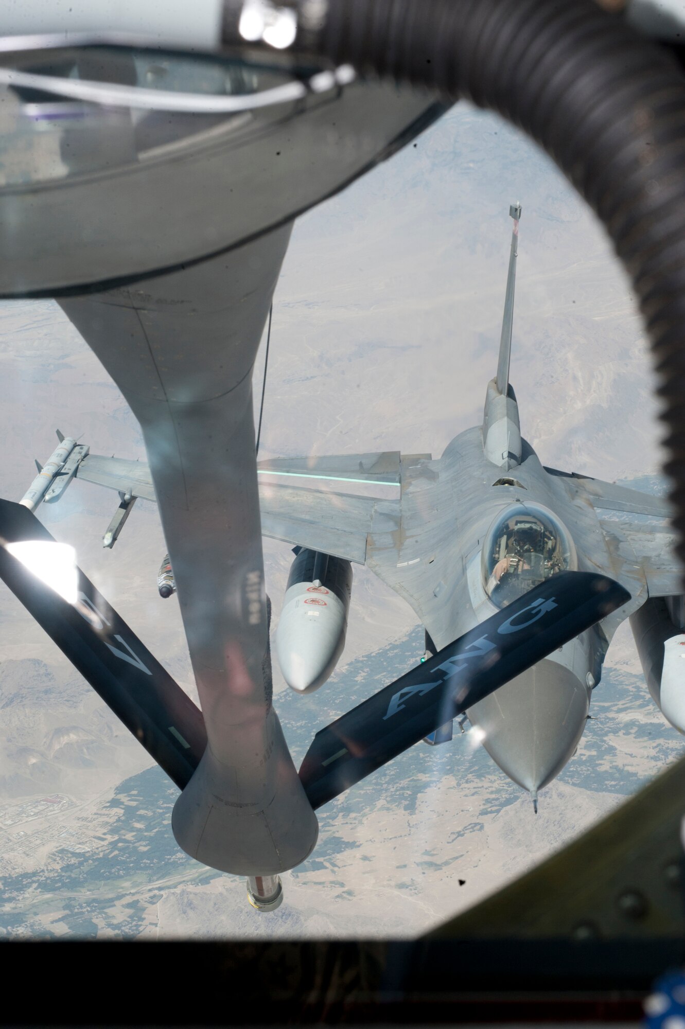 An F-16 Fighting Falcon approaches the boom of a KC-135 Stratotanker for refueling over Afghanistan, July 25, 2013. The KC-135, assigned to Transit Center at Manas, Kyrgyzstan, offers in-flight refueling to allow various military aircraft to stay in the fight longer. (U.S. Air Force photo/Staff Sgt. Robert Barnett)