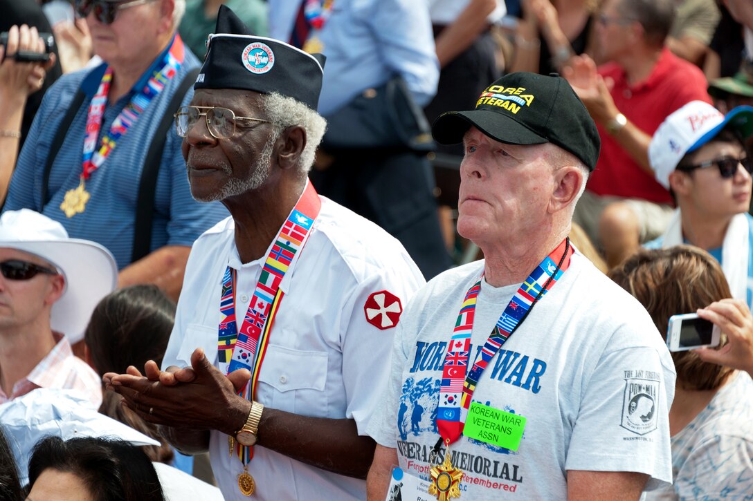 Korean War veterans watch Korean children perform during the ceremony marking the 60th anniversary of the armistice ending the Korean War at the Korean War Memorial in Washington, D.C., July 27, 2013.
