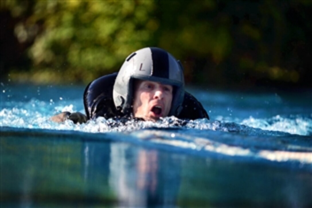 Air Force Lt. Col. Steve Horton stays afloat while being dragged by a parachute harness during water survival training at Spangdahlem Air Base, Germany, July 19, 2013. Horton is the commander, 52nd Operations Group. Pilots must learn how to disengage from a parachute while being dragged across open water by the wind to ensure their safety in real-world situations.