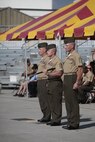 Sgt. Maj. John Elliot (middle) holds the noncommissioned officer’s sword, the symbol of his new responsibility as Marine Aircraft Group 29 sergeant major, while Col. Peter D. Buck, 2nd Marine Air Wing chief of staff, and Sgt. Maj. Bradley Prafke, off-going MAG-29 sergeant major, stand at attention during a relief and appointment ceremony, July 26. 