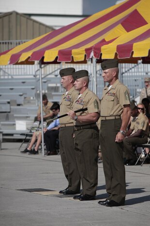 Sgt. Maj. John Elliot (middle) holds the noncommissioned officer’s sword, the symbol of his new responsibility as Marine Aircraft Group 29 sergeant major, while Col. Peter D. Buck, 2nd Marine Air Wing chief of staff, and Sgt. Maj. Bradley Prafke, off-going MAG-29 sergeant major, stand at attention during a relief and appointment ceremony, July 26. 