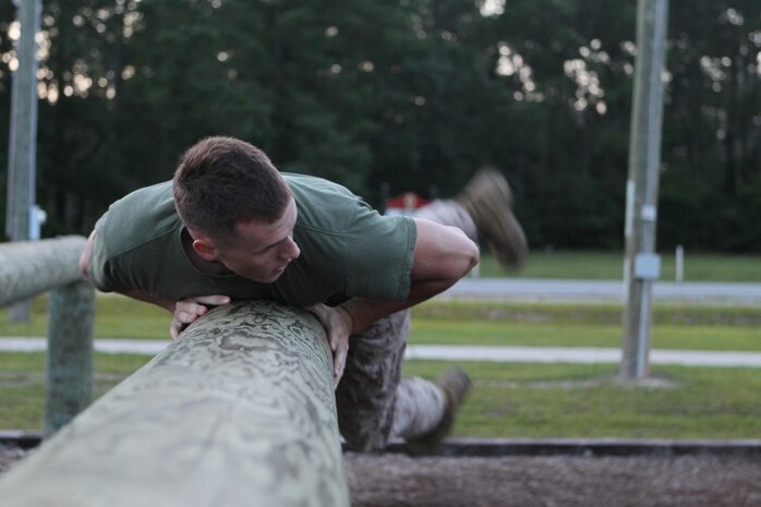 Midshipmen tackle the obstacle course aboard Camp Geiger, July 23. The midshipmen are here during their career orientation and training for midshipmen Marine week. 