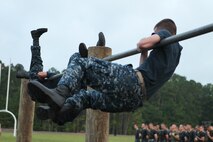 Midshipmen tackle the obstacle course aboard Camp Geiger, July 23. The midshipmen are here during their career orientation and training for midshipmen Marine week.