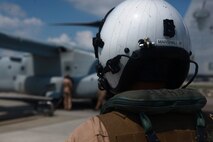Marines from Marine Medium Tiltrotor Squadron 261 carry a parachute load to an MV-22B Osprey for parachute operations, July 25