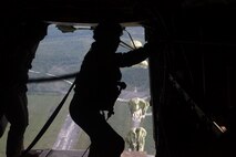Marines prepare themselves as they stand by to jump out of the back of an MV-22B Osprey, July 25.