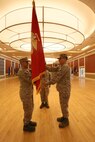 Navy Capt. Rodney L. Gunning (left) receives the battalion colors from Capt. Fransisco R. Leal (right) during a change of command ceremony aboard Camp Lejeune, N.C., July 29, 2013. Second Dental Battalion, Naval Dental Center, 2nd Marine Logistics Group held the ceremony to signify an orderly transfer of responsibility and accountablity from one commander to another.