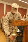 Petty Officer 3rd Class Ethan Bright, operating as the official time orderly for a change of command ceremony, rings the bell four times to signal that a Navy captain was departing the room. Second Dental Battalion, Naval Dental Center, 2nd Marine Logistics Group welcomed a new commanding officer during the ceremony held aboard Camp Lejeune, N.C., July 29, 2013.