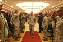 Navy Capt. Francisco R. Leal (center), the outgoing commanding officer of 2nd Dental Battalion, Naval Dental Center, 2nd Marine Logistics Group, salutes the sideboys while exiting the room after a change of command ceremony held aboard Camp Lejeune, N.C., July 29, 2013. Leal relinquished command to Capt. Rodney L. Gunning and will move on to an assignment in Washington, D.C.