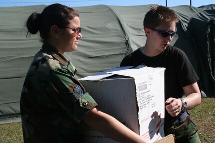 Technical Sgt. Melissa DiQuinzio of the 143rd Medical Group, Rhode Island Air National Guard, and Staff Sgt. Devin Boggan, 187th Medical Group, Alabama Air National Guard, , unpack medical equipment to be used during Vigilant Guard 2008, a disaster response training exercise based in Beaufort County, S.C., April 20, 2008. Vigilant Guard is one of the largest disaster response training exercises in the history of the National Guard, involving more than 3,000 Soldiers and Airmen from more than a dozen states.