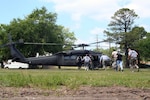 Victims of the 'rubble pile' hurry to the UH-60 Blackhawk to be evacuated to a local hospital during the Vigilant Guard 2008 exercise in Beaufort, S.C.