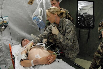 Capt. Pauline Goss, of the 187th Medical Group, attends to a simulated disaster victim during National Guard exercise Vigilant Guard April 22 in Beaufort, S.C. Vigilant Guard is a three-day National Guard-hosted exercise involving a mock 7.3 scale earthquake, in Beaufort County, which began April 21. The exercise is designed to better prepare the National Guard for natural disasters in a cooperative effort with various national, state and local government agencies.