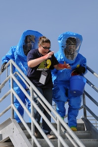 Mock casualty Blakely McClellan recieves assistance from the Nevada Army National Guard's 92nd Civil Support Team team during the Vigilant Guard exercise in Reno on June 14. The exercise scenario that day included a hazardous material spill that endangered civilians.