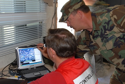 Tech. Sgt. Brian Guettler, right, an airman in the Nevada National Guard's Counterdrug Task Force, and Steve Endacott, the Vigilant Guard exercise coordinator for Churchill County, prepare the remote operated video enhanced receiver (ROVER) to receive a video signal from the MQ-1 Predator unmanned aerial vehicle in Fallon, Nev., on June 13. (U.S. Air Force photo by 