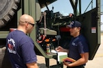 Army Staff Sgt. Thomas (left), a 233rd Engineering Det. firefighter, receives a briefing from Staff Sgt. Esparza, 233rd ED team chief.