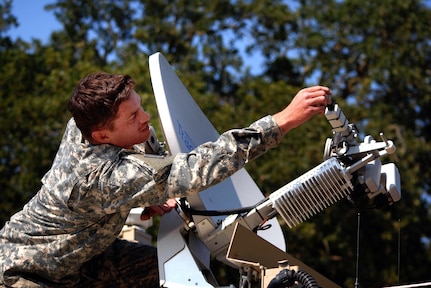 Spc. Shaun Ochsner, communications specialist, makes adjustments to a sattelite atop an Incident Commander's Command, Control and Communications Unit (IC4U) at Booneville, Calif. The California National Guard mobilized five IC4Us to run operations in support of Operation Lightning Strike.