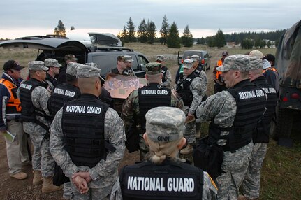 Members of the Washington National Guard 10th Weapons of Mass Destruction-Civil Support Team prepare to enter Leschi Town early May 2 at Fort Lewis, Wash., during National Level Exercise 2008. The Department of Homeland Security exercise was designed to test local, state, federal and military responders to perform roles and responsibilities related to homeland defense in the event of a catastrophic emergency. This exercise was in response to a simulated terrorist attack using a chemical agent.