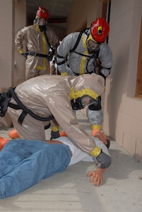 Washington National Guard Soldiers with the state's Chemical, Biological, Radiological, Nuclear and high-yield Explosive Enhanced Response Force Package transport a mock ambulatory patient to medical care during "National Level Exercise 2008".