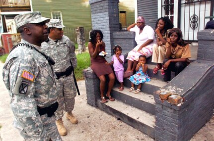 Sgts. Willie Clark, left, and Wayne Lewis talk with residents as they patrol in New Orleans, Friday, July 31, 2008. JTF Gator has been providing law enforcement assistance to the New Orleans Police Department and is scheduled to cease operations on Dec. 31, 2008.