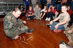 Air Force Tech. Sgt. Bobby Vickery (left), leads 20 students through the "paradigm shift" activity during the Guard Adventure Program at Gardiner Middle School in Oregon City, Ore., on Mar. 3, 2009. The program, administered by the Oregon National Guard's Counterdrug Support Program, aims to instill positive interpersonal skills and teach anti-drug awareness to Oregon's school-aged children.
