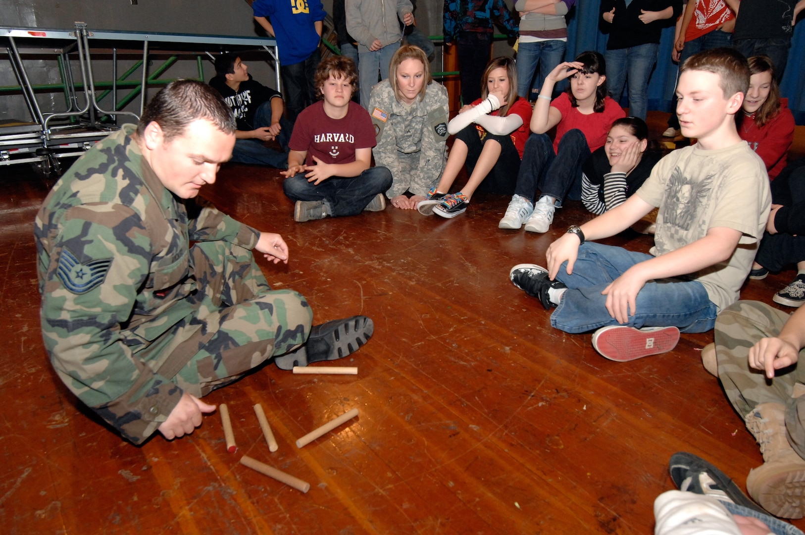 Air Force Tech. Sgt. Bobby Vickery (left), leads 20 students through the "paradigm shift" activity during the Guard Adventure Program at Gardiner Middle School in Oregon City, Ore., on Mar. 3, 2009. The program, administered by the Oregon National Guard's Counterdrug Support Program, aims to instill positive interpersonal skills and teach anti-drug awareness to Oregon's school-aged children.