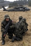 Slovenian Soldiers prepare to board a U.S. UH-60 Blackhawk during a multinational training exercise at the Joint Multinational Readiness Center’s Camp Albertshof in Hohenfels, Germany. The Slovenians were part of the mission readiness exercise for U.S. reserve component Soldiers preparing for the 11th iteration of the Kosovo Force in support of Operation Joint Guardian.