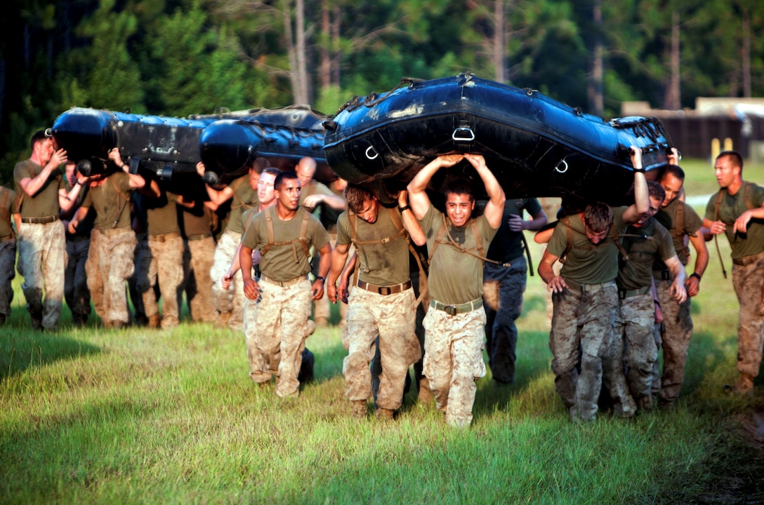 Marines with 2nd and 4th Combat Engineer Battalion and 8th Engineer Support Battalion run with Combat Rubber Reconnaissance Crafts during a morning physical training session at the Sapper leader Course here July 25. The students in the course were put through rigorous combat training that challenged them both physically and mentally in order to gain the title "Sapper". The two-week course was the first of its kind, designed for Reserve Marines to recieve advanced training in the combat engineer military occupational specialty. (U.S. Marine Corps photo by Cpl. Marcin. Platek) 
