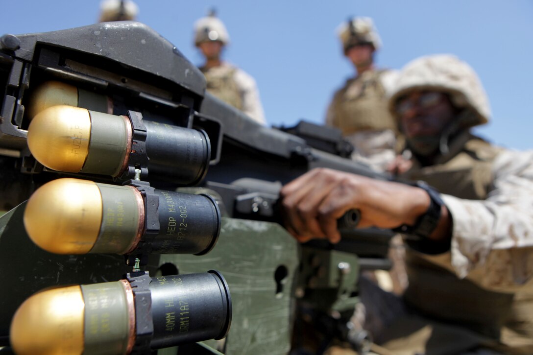 Lance Cpl. John Bailey II, a bulk fuel specialist with Bulk Fuel Company B, 6th Engineer Support Battalion, and native of Largo, Md., loads a MK19 40mm grenade launcher during a crew-served weapons range here, July 16. Bulk fuel Marines practiced setting up fueling positions and protecting those positions from notional enemy combatants. Marines responsible for guarding the fuel conducted a series of live fire ranges to become more proficient with their service rifles and crew-served weapons. 