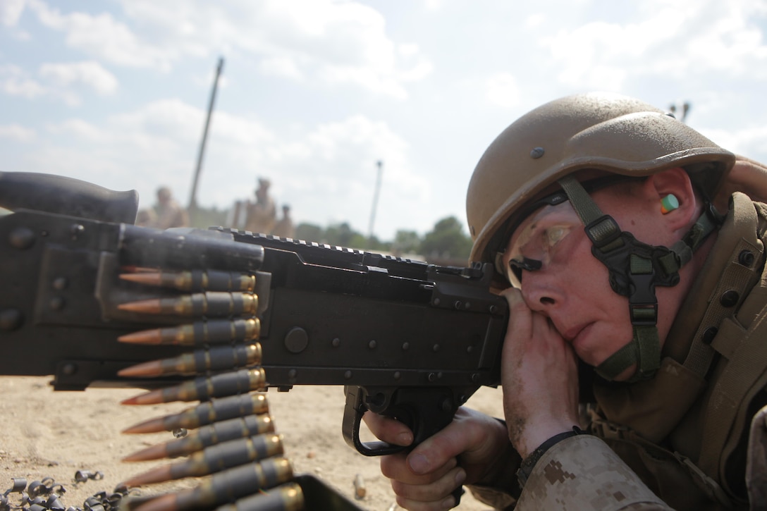 Cpl. Matthew Granas, a bulk fuel specialist with Bulk Fuel Company B, 6th Engineer Support Battalion, and native of Fords, N.J., fire a M-240B machine gun during a crew-served weapons range here, July 16. Bulk fuel Marines practiced setting up fueling positions and protecting those positions from notional enemy combatants. Marines responsible for guarding the fuel conducted a series of live fire ranges to become more proficient with their service rifles and crew-served weapons. 