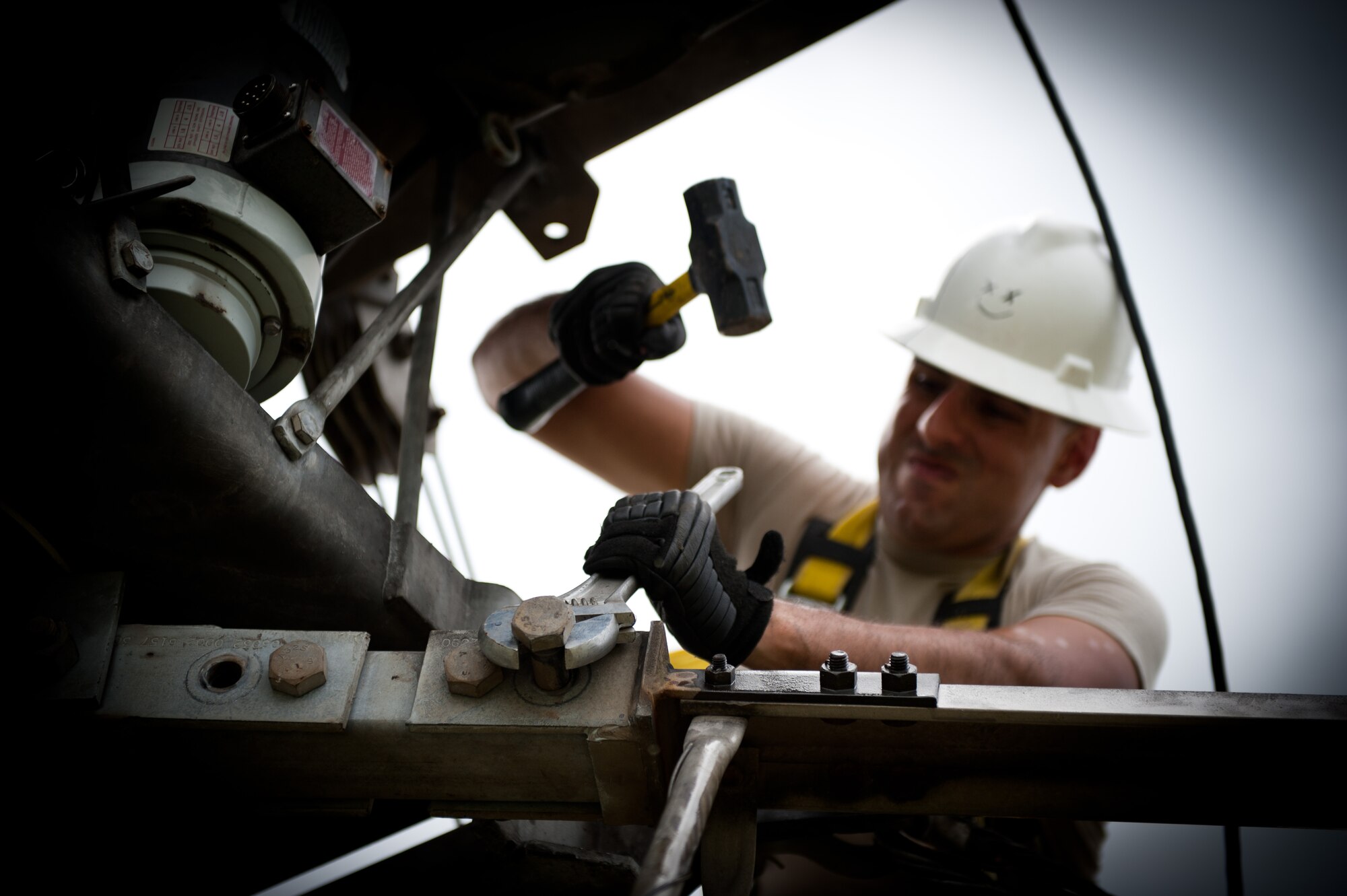 Airman 1st Class David Herrera, 374th Communications Squadron cable and antenna maintenance technician, removes a bolt from a rotatable log periodic antenna July 26, 2013, at the Tokorozawa Communication Site, Japan. The bolt removal made the antenna’s arm lay lower to the ground, allowing Herrera and his team to easily replace crystalline plastic used as support bridges between antenna segments. (U.S. Air Force photo by Senior Airman Cody H. Ramirez)