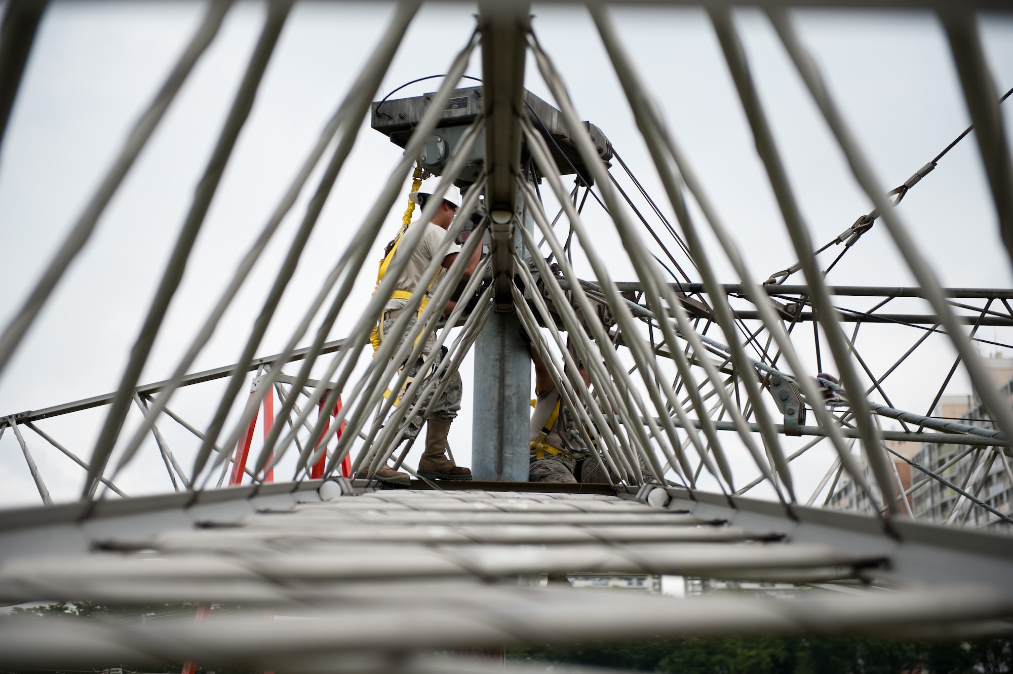 Airmen 1st Class David Herrera and Monico Viloria, 374th Communications Squadron cable and antenna maintenance technicians, work together to loosen a bolt on a rotatable log periodic antenna during scheduled maintenance July 26, 2013, at the Tokorozawa Communication Site, Japan. The antennas at Tokorozawa provide communication support to a variety of Department of Defense installations including Misawa Air Base and Yokosuka Naval Base. (U.S. Air Force photo by Senior Airman Cody H. Ramirez)