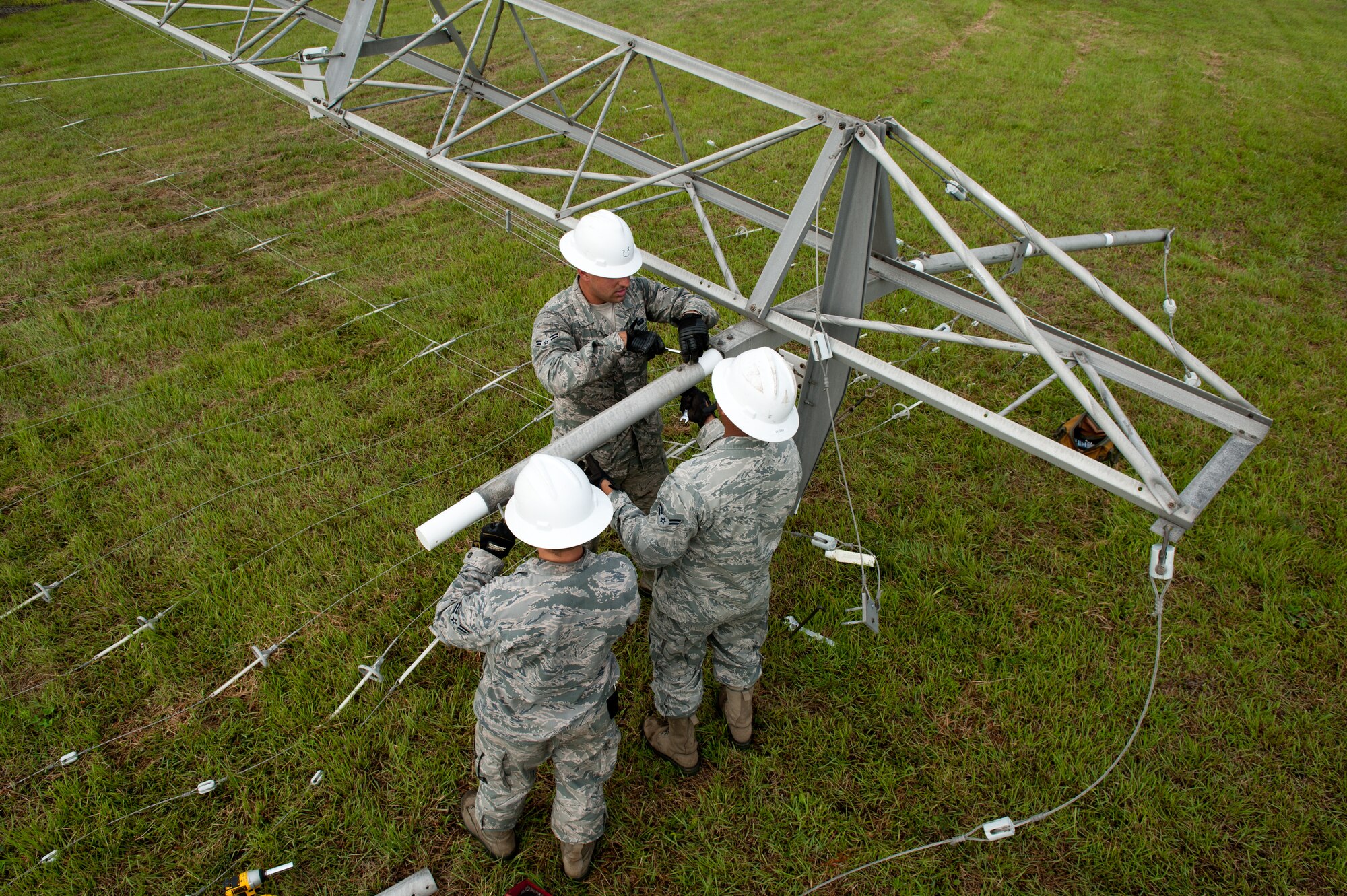 Airmen from the 374th Communications Squadron cable and antenna maintenance shop replace crystalline plastic on a rotatable log periodic antenna July 26, 2013, at the Tokorozawa Communication Site, Japan. The antenna provides directional communication for bases such as Misawa Air Base and Yokosuka Naval Base. (U.S. Air Force photo by Senior Airman Cody H. Ramirez)