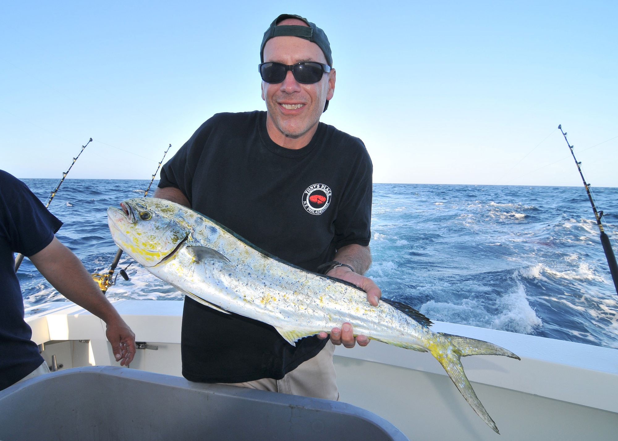 A picture of U.S. Army Sgt. First Class Patrick Fry, flight operations Soldier with the 57th Troop Command, New Jersey Army National Guard, holding a mahi mahi.