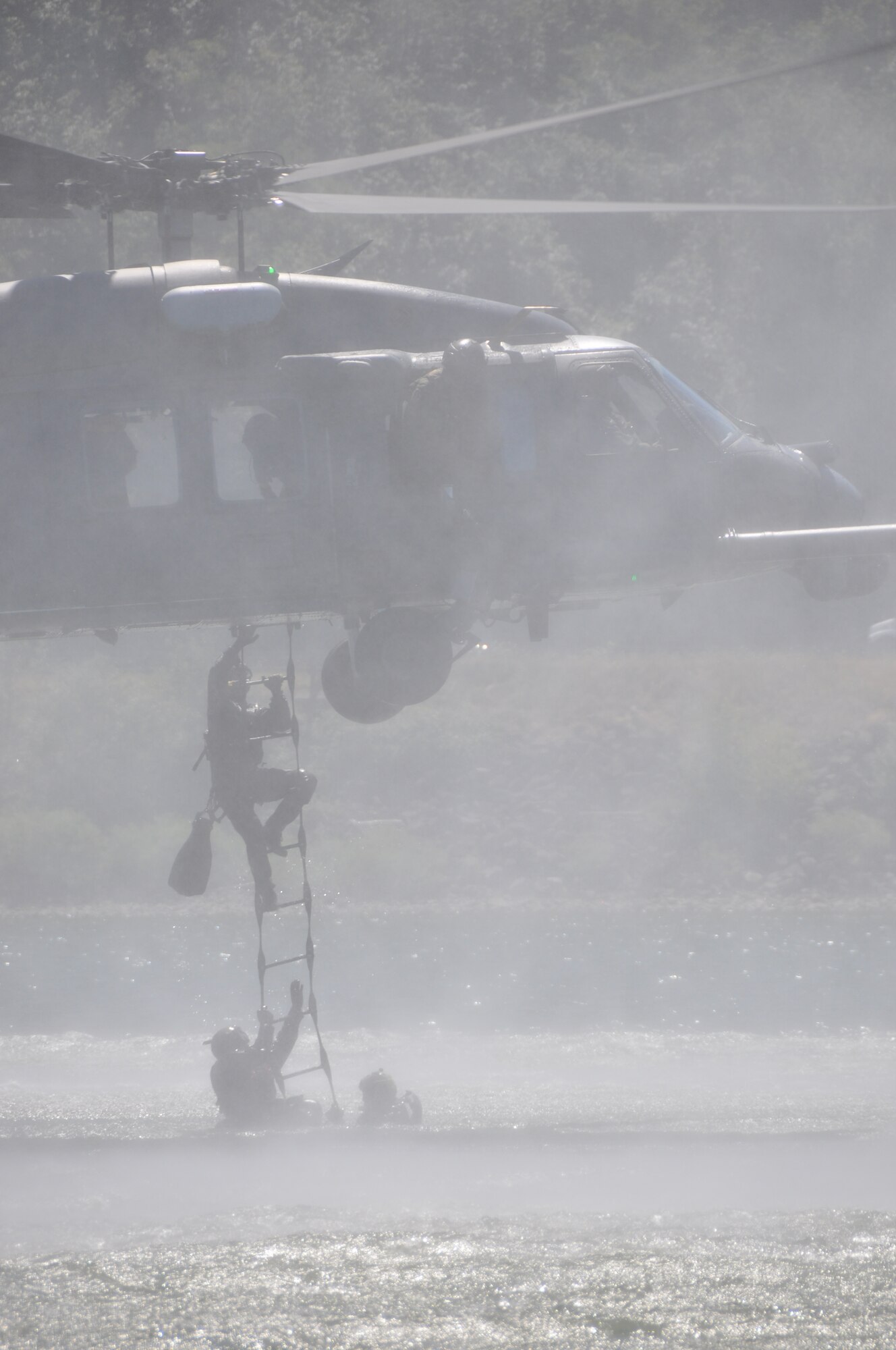 Pararescuemen from the 304th Rescue Squadron, Portland International Airport, Ore. board an HH-60G Pave Hawk helicopter from the 943rd Rescue Group, Davis-Monthan Air Force Base, Ariz. The 304th RQS and 943rd RQG practiced water rescue operations in the Columbia River, near Rooster Rock State Park, Ore., July 27, 2013. (U.S. Air Force Photo/Staff Sgt. N. Daniel Delgado)