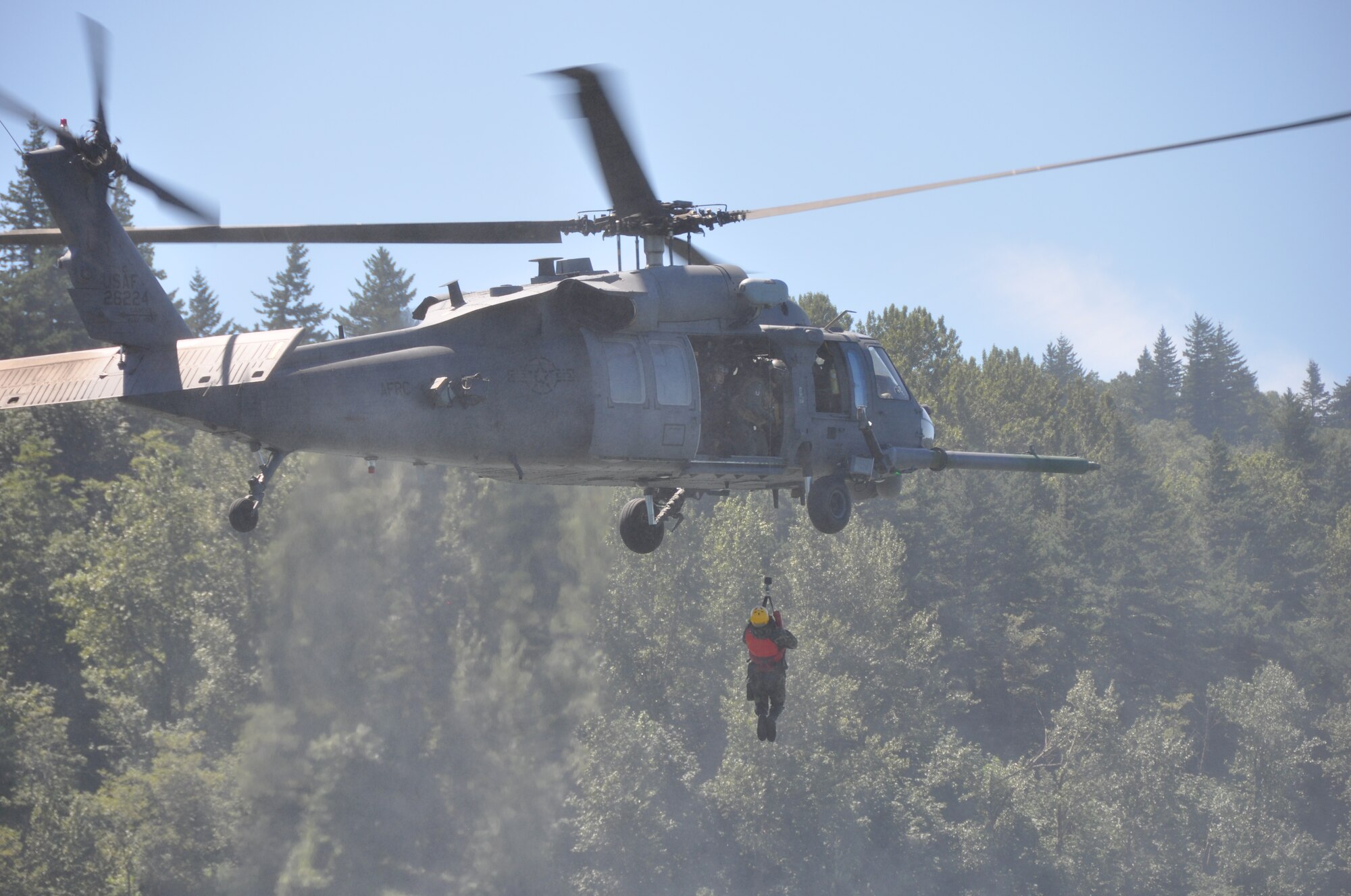 Pararescuemen from the 304th Rescue Squadron, Portland International Airport, Ore., aboard an HH-60G Pave Hawk helicopter from the 943rd Rescue Group, Davis-Monthan Air Force Base, Ariz., practice water rescue operations in the Columbia River, near Rooster Rock State Park, Ore., July 27, 2013. (U.S. Air Force Photo/Staff Sgt. N. Daniel Delgado)