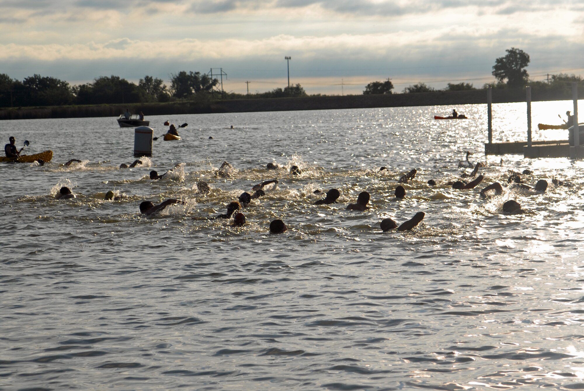 SAN ANGELO, Texas – Triathletes race to a buoy 200 meters away from the shore at Lake Nasworthy during the 2013 Annual Triathlon at Goodfellow Reaction Camp July 27. All branches of the base were invited to participate in the triathlon promoting a joint service environment.  (U.S. Air Force photo/ Airman 1st Class Breonna Veal)
