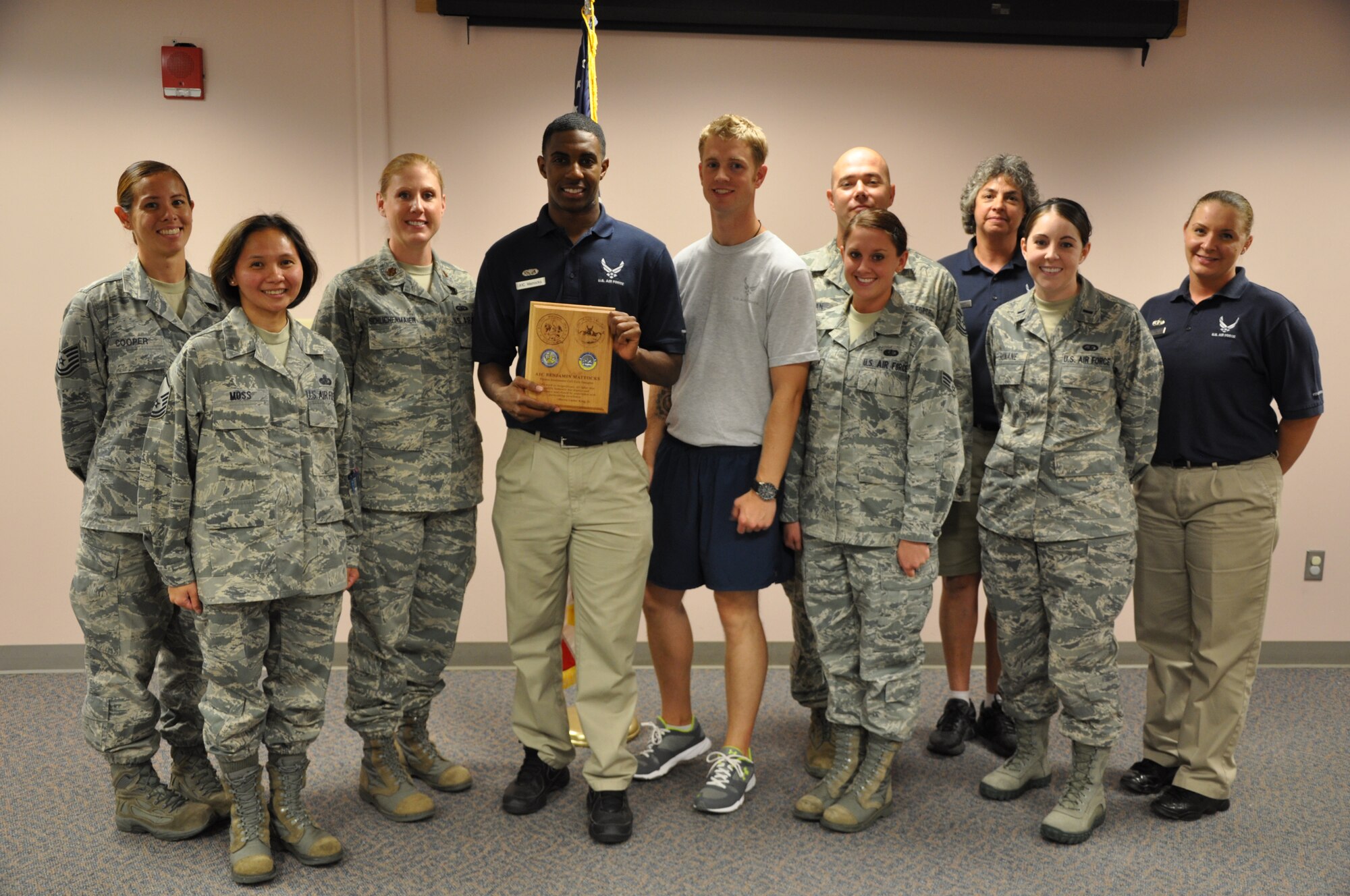 PETERSON AIR FORCE BASE, Colo. –Maj. Tammy Schlichenmaier, 21st Force Support Squadron commander, stands with the staff and augmentees of the Fitness Assessment Cell at the Peterson Sports and Fitness Center during a recognition ceremony July 19. During the ceremony Schlichenmaier presented the first batch of FAC coins to her team members in recognition of their service and professionalism at the FAC. It was also an opportunity to say “thank you” to the many Airmen who have performed the augmentee duty. (U.S. Air Force photo/Michael Golembesky)