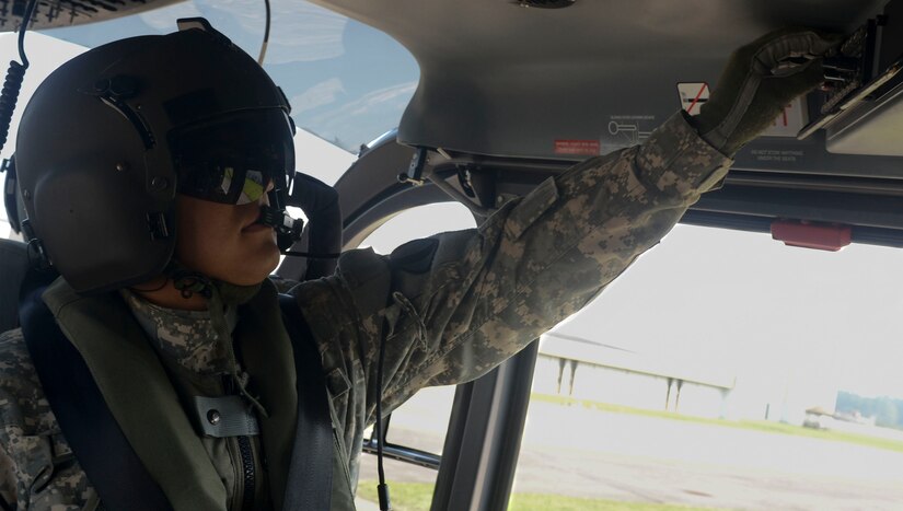 U.S. Army Staff Sgt. Daniel Roman, Training and Doctrine Command flight section noncommissioned officer in charge, adjusts the cabin controls of a UH-72A light utility helicopter at Fort Eustis, Va., July 19, 2013. The cabin typically holds five passengers, but can also be used to hold two litters when changed to a medical-evacuation configuration. (U.S. Air Force photo by Airman 1st Class Austin Harvill/Released)