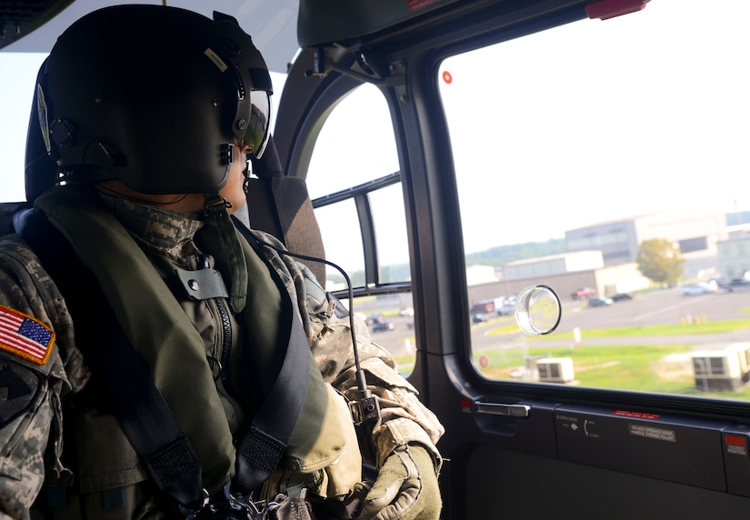 U.S. Army Staff Sgt. Daniel Roman, Training and Doctrine Command flight section noncommissioned officer in charge, gazes out the window before landing at the Training and Doctrine Command commander’s pick-up location at Fort Eustis, Va., July 19, 2013. The helicopter crew members are seasoned combat veterans, specifically selected for the job of transporting the TRADOC commander. (U.S. Air Force photo by Airman 1st Class Austin Harvill/Released)