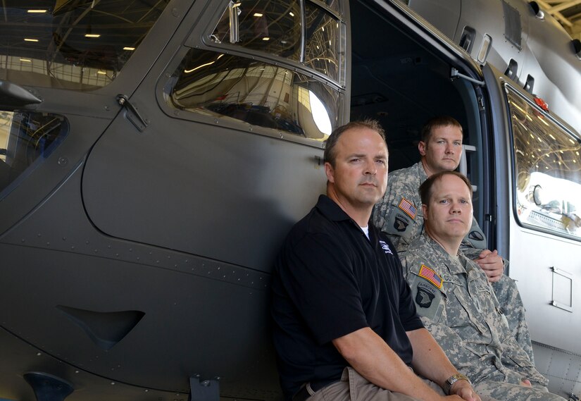 From left to right, Rob Schoerner, U.S. Army Chief Warrant Officer 4 Scott Cotriss and U.S. Army Chief Warrant Officer 3 Mark Smith, U.S. Army Training and Doctrine Command flight detachment pilots, have flown more than 10,000 hours combined. Only seasoned pilots fly for the TRADOC flight detachment, which is the TRADOC commander’s personal helicopter transport detachment. (U.S. Air Force photo by Airman 1st Class Austin Harvill/Released)