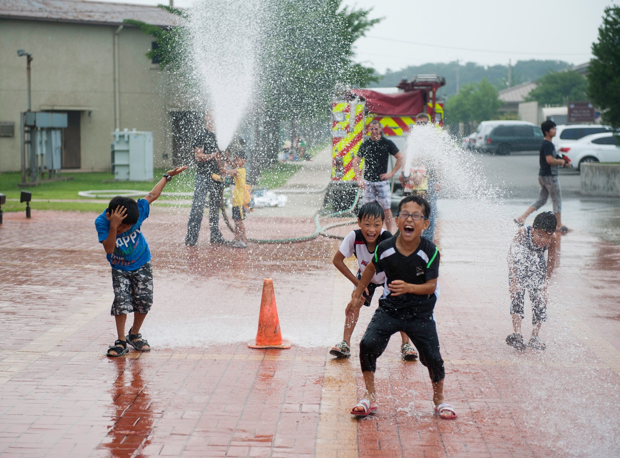 Children from the Ilmagwon Orphanage play with fire hoses during Summer Fun Day, at Kunsan Air Base, Republic of Korea, July 27, 2013. The base’s fire department ran the fire hose station as part of a larger event organized by the Airmen Committed to Excellence council. (U.S. Air Force photo by Senior Airman Clayton Lenhardt/Released)