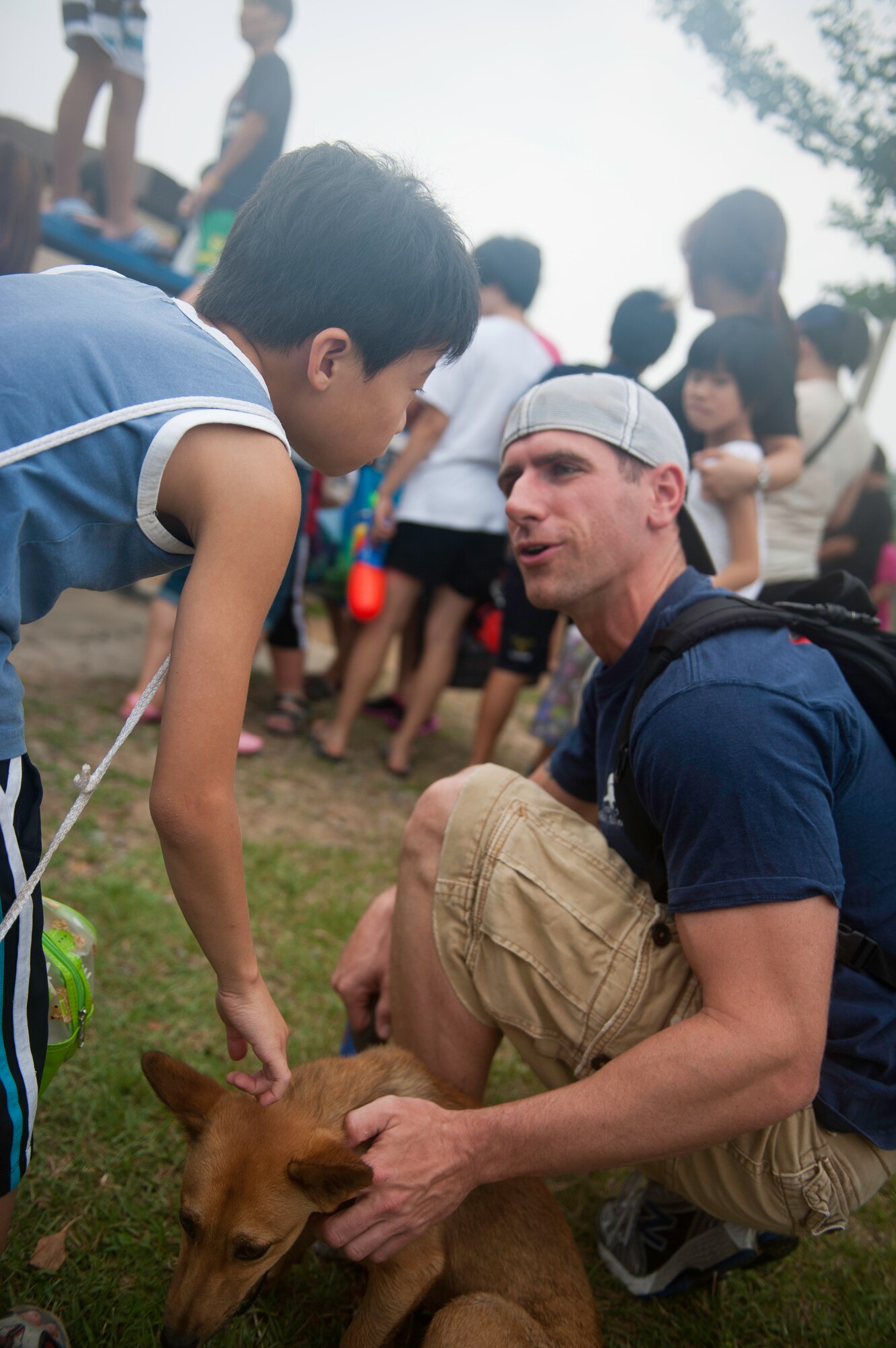 Master Sgt. Ryan Bobzin, 8th Civil Engineer Squadron, speaks with a child from the Ilmagwon Orphanage during Summer Fun Day, at Kunsan Air Base, Republic of Korea, July 27, 2013. The day’s events were organized by the Airmen Committed to Excellence Council and gave children from the orphanage a chance to have fun with members of the Wolf Pack. (U.S. Air Force photo by Senior Airman Clayton Lenhardt/Released)