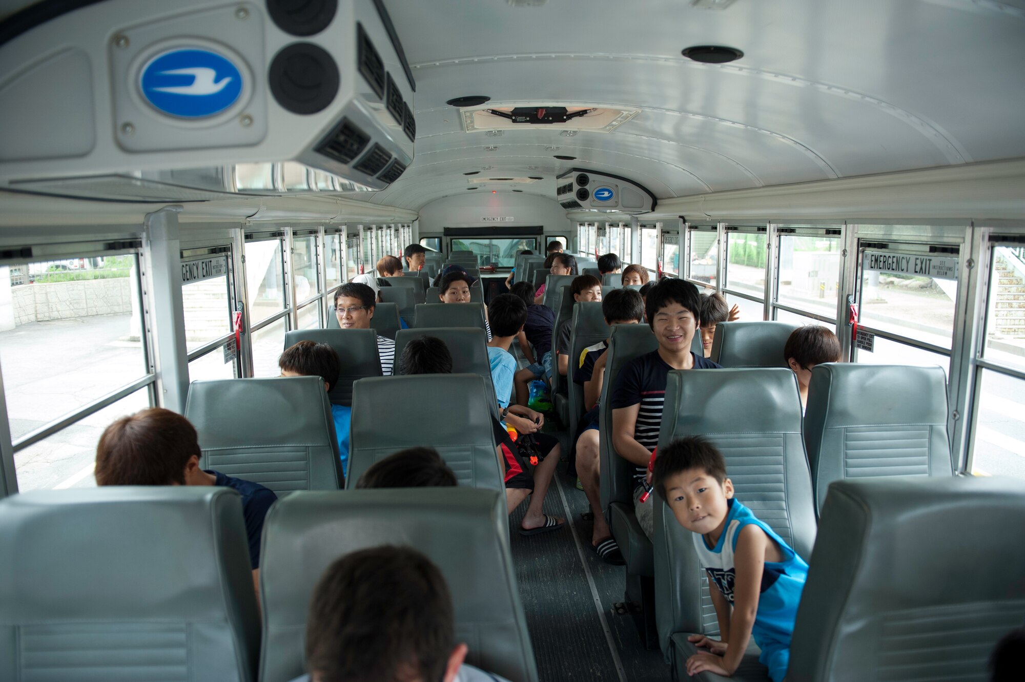 Children from the Ilmagwon Orphanage await transportation to Kunsan Air Base, Republic of Korea, for Summer Fun Day July 27, 2013 in Gunsan City. Kunsan Air Base’s Airmen Committed to Excellence Council invited the orphanage to the event, which features numerous activities for the children ran by volunteers from the Wolf Pack. (U.S. Air Force photo by Senior Airman Clayton Lenhardt/Released)