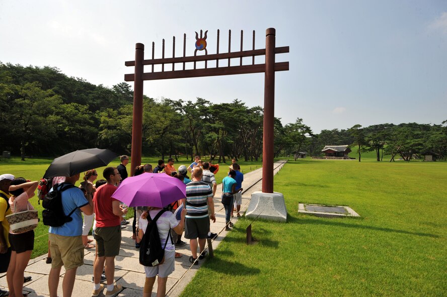 Participants in the Yeoju cultural tour prepare to walk through the Hongslmun gate, which signifies that they are about to enter a sacred area at King Sejong’s tomb in the Gyeonggi Province, Republic of Korea,  July 26, 2013. Once people pass through the gate, they are all told to walk on the side of the path since the elevated middle portion is reserved for gods. (U.S. Air Force photo/Staff Sgt. Emerson Nuñez)