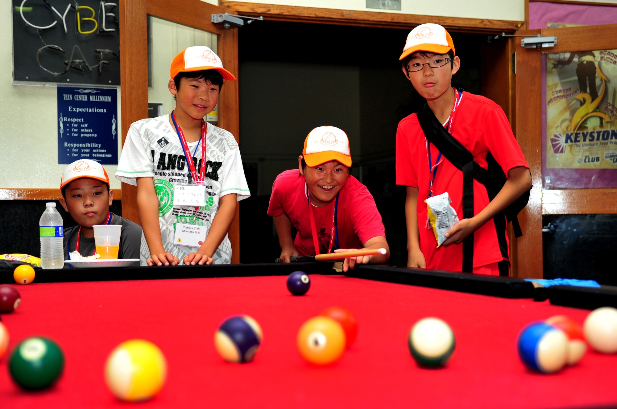 Japanese sixth-graders from Iitate Village play pool at the Nakayoshi Youth Programs Complex during a school visit on Kadena Air Base, Japan, July 24, 2013. The students spent the afternoon playing games and enjoying lunch with American military children in an effort to promote peace. (U.S. Air Force photo by Senior Airman E. N. Jacobs/Released)