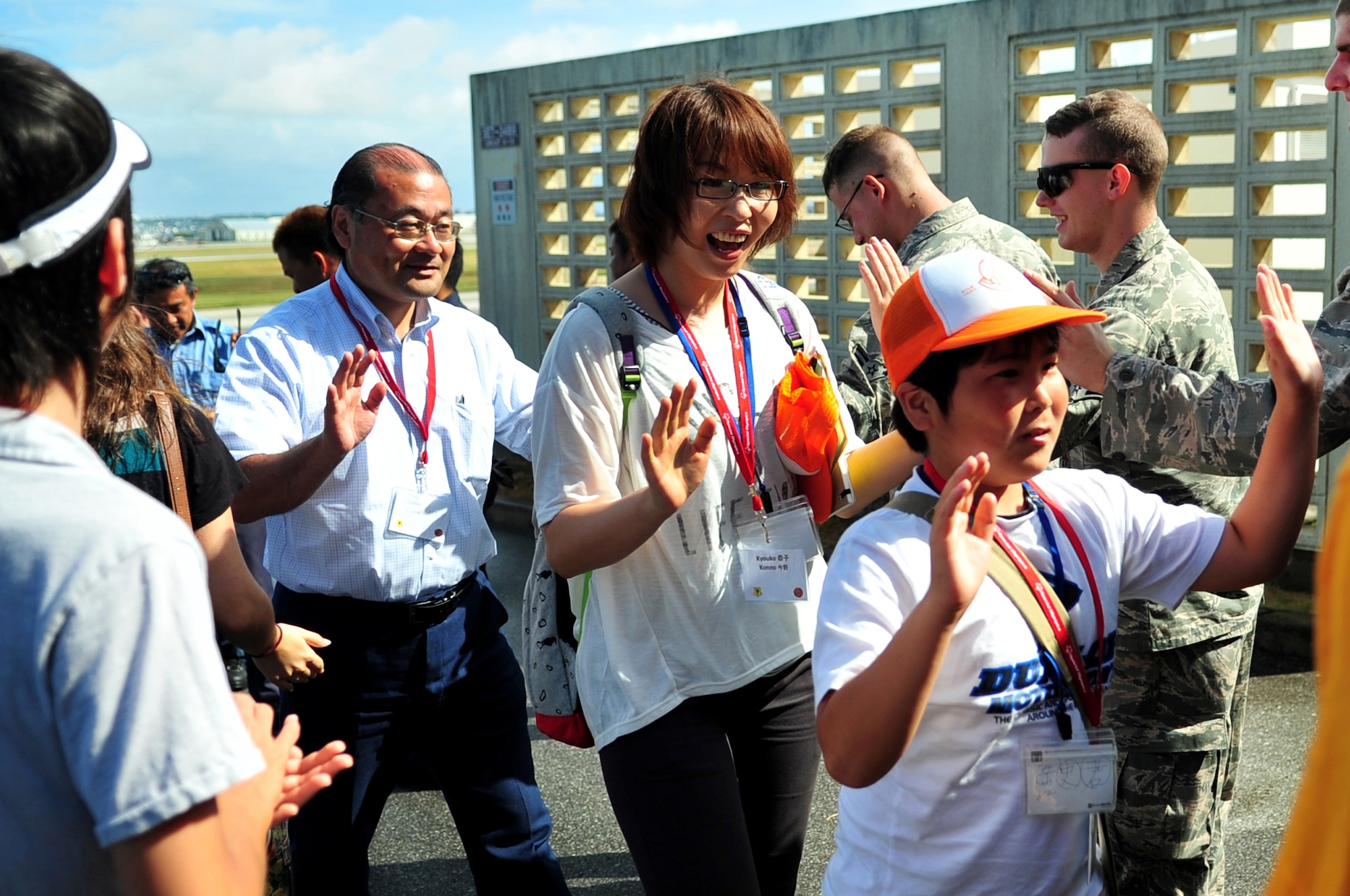 U.S. Air Force Airmen and American military children welcome Japanese sixth-graders and escorts from Iitate Village to Kadena Air Base, Japan, July 24, 2013. The students had the opportunity to watch several rescue demonstrations in order to learn more about the peaceful operations the U.S. military performs. (U.S. Air Force photo by Senior Airman E. N. Jacobs/Released)