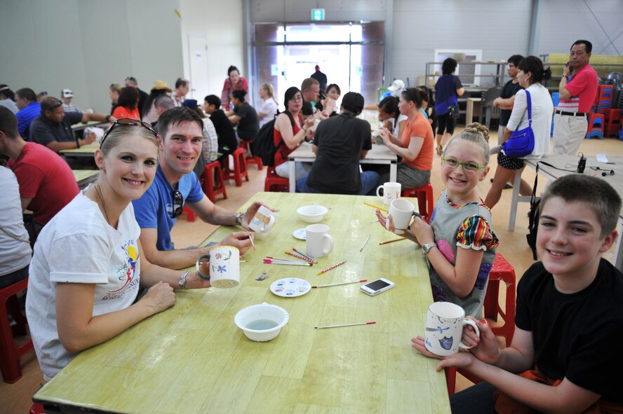 The Griffith family shows off their finished works of art during the Yeoju culture tour at the Yeoju Ceramic Center in the Gyeonggi Province, Republic of Korea, July 26, 2013. Participants in the tour were given a chance to paint on ceramic mugs during the cultural tour, which was sponsored by the Korea America Friendship Society. (U.S. Air Force photo/Staff Sgt. Emerson Nuñez)